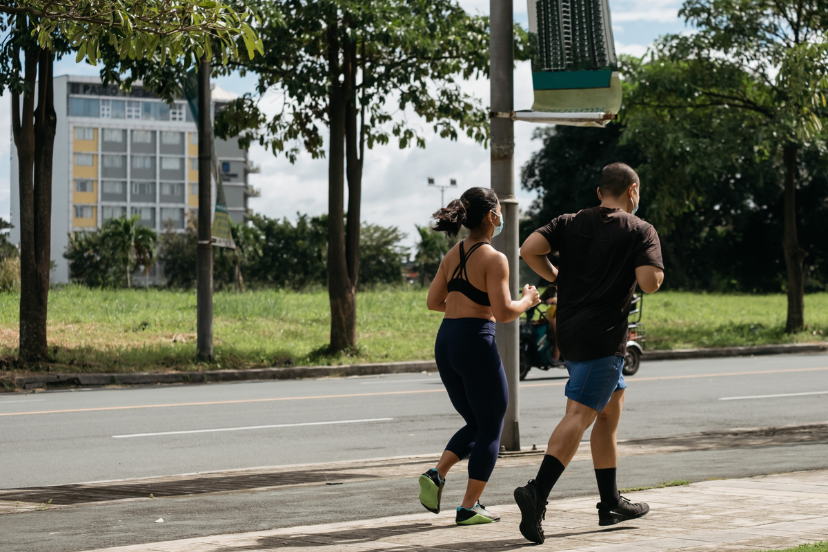 Man and Woman Wearing Face Mask Running Outdoors 